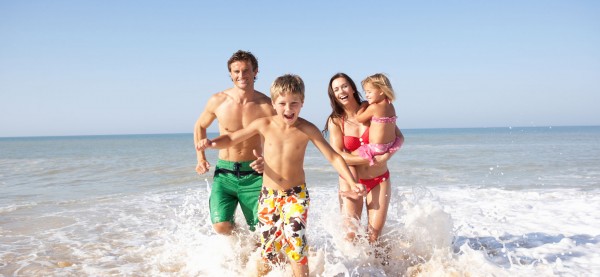 family running in ocean