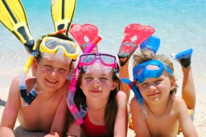 Kids with snorkels on laying on the beach